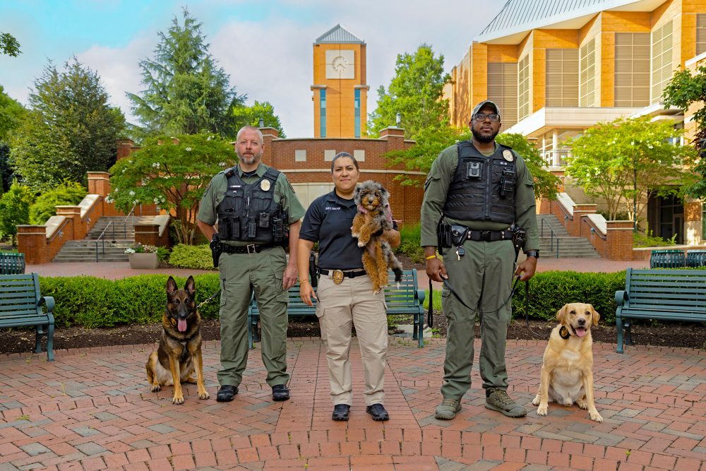Three K-9s and their handlers in Cauble Quad