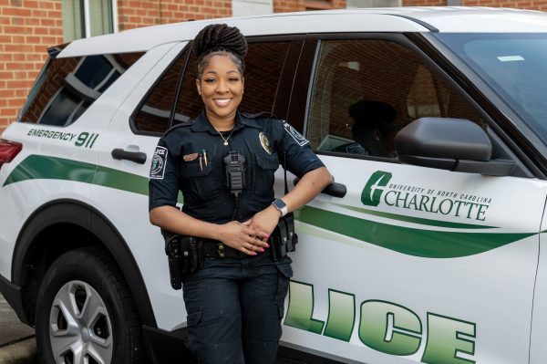 Cpl Cullars in front of a police vehicle